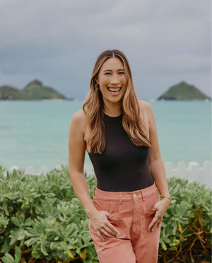 Dr. Leah Karp smiling by the ocean, sharing how Hem supports pelvic floor health through every stage of life.